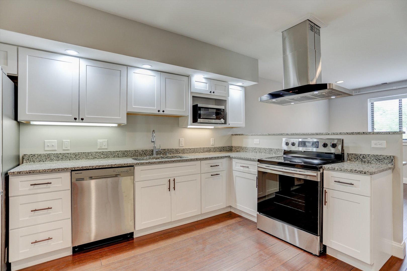 218 West Main Street Urbana, IL 61801 - Photo 65 of 96 a kitchen with granite countertop white cabinets white stainless steel appliances and sink
