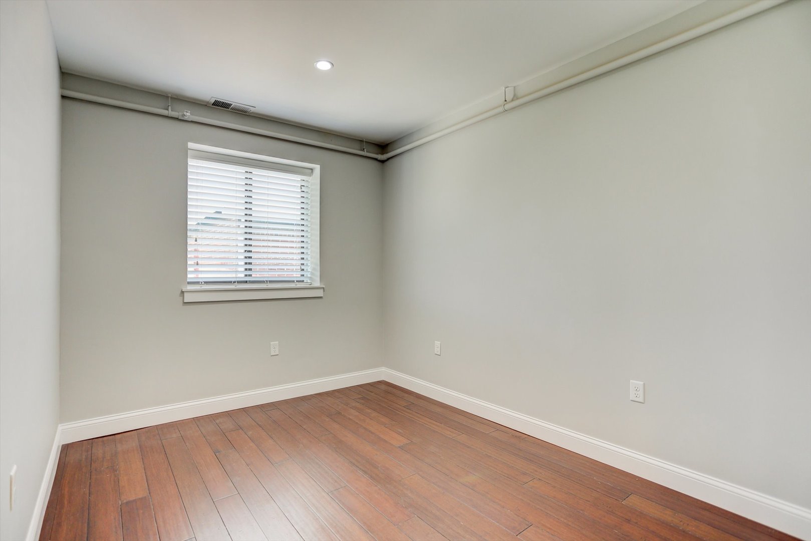 218 West Main Street Urbana, IL 61801 - Photo 72 of 96 an empty room with wooden floor and windows