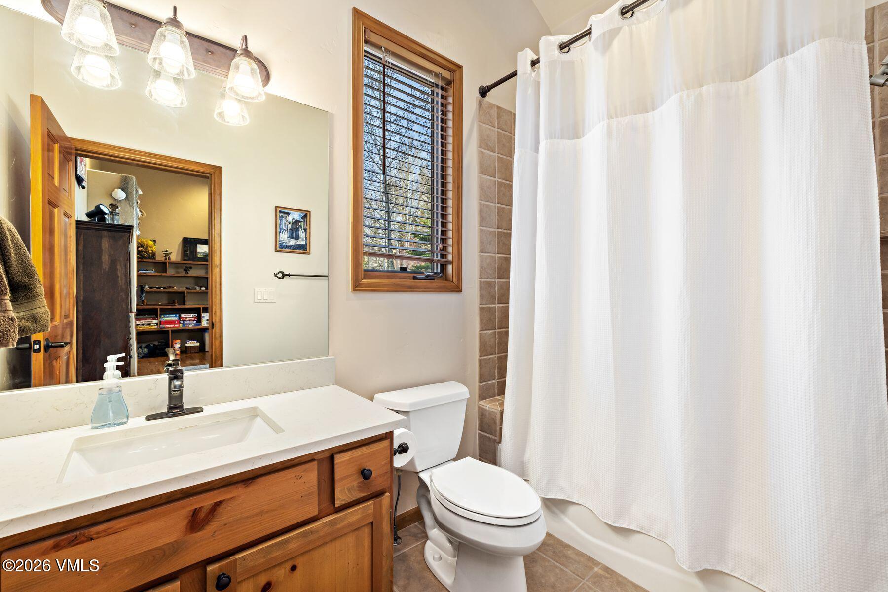 91 Creamery Trail Edwards, CO 81632 - Photo 31 of 44 a bathroom with a sink vanity mirror and toilet