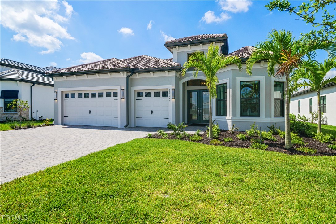 18377 Ridgeline Drive Estero, FL 33928 - Photo 1 of 50 a view of a house with potted plants and a yard