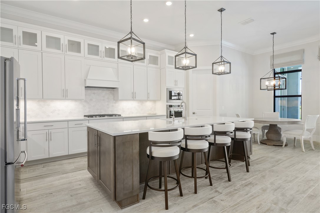 18377 Ridgeline Drive Estero, FL 33928 - Photo 12 of 50 a kitchen with center island table and chairs in it