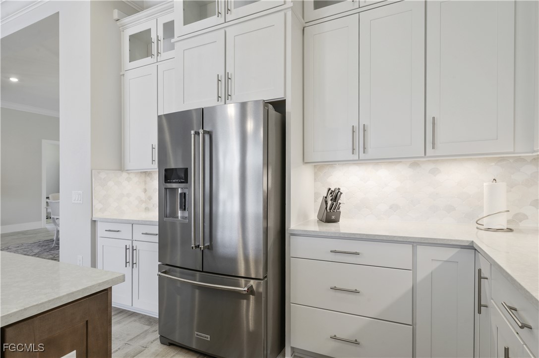 18377 Ridgeline Drive Estero, FL 33928 - Photo 13 of 50 a kitchen with appliances and cabinets