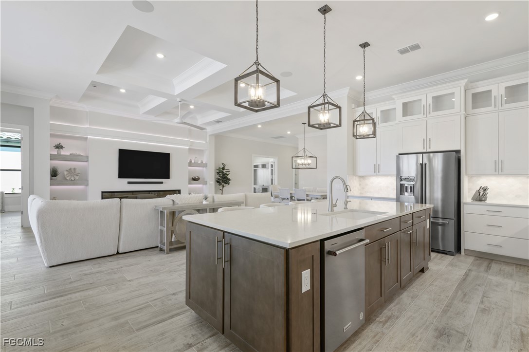 18377 Ridgeline Drive Estero, FL 33928 - Photo 14 of 50 a kitchen with a counter space cabinets and stainless steel appliances