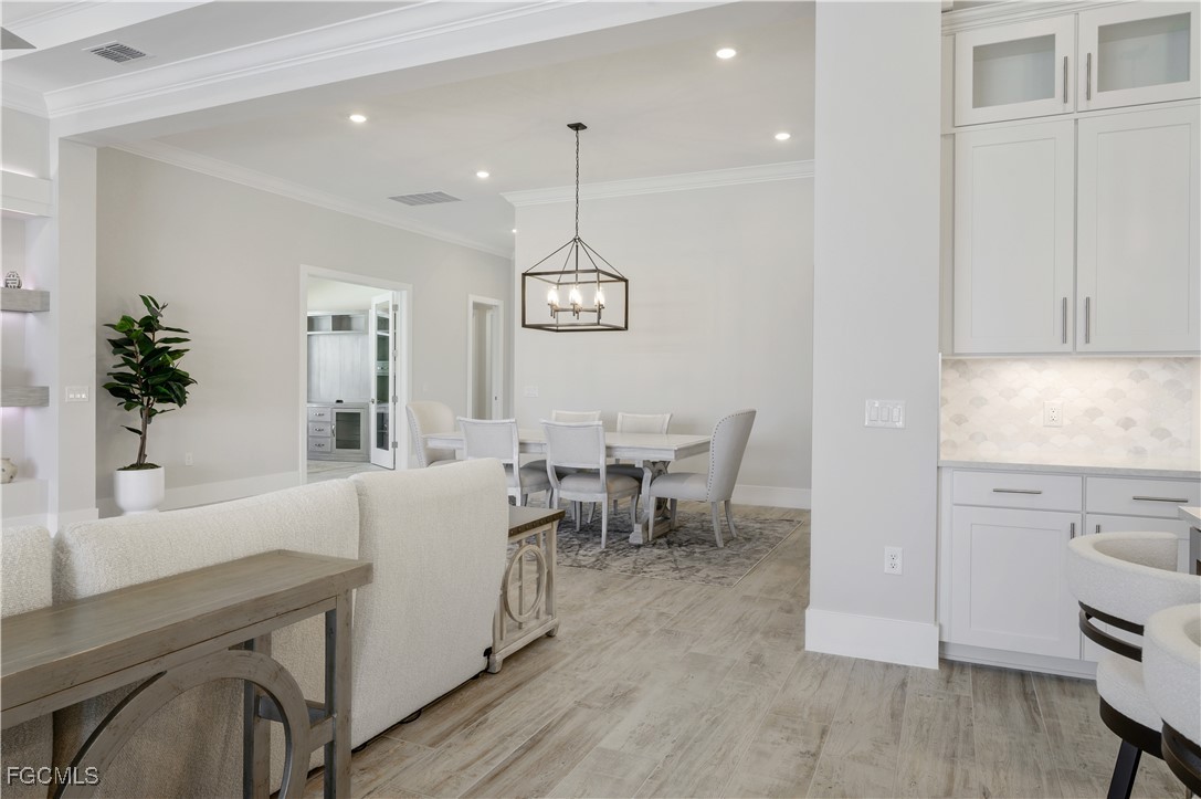 18377 Ridgeline Drive Estero, FL 33928 - Photo 20 of 50 a living room with furniture a dining table and a potted plant