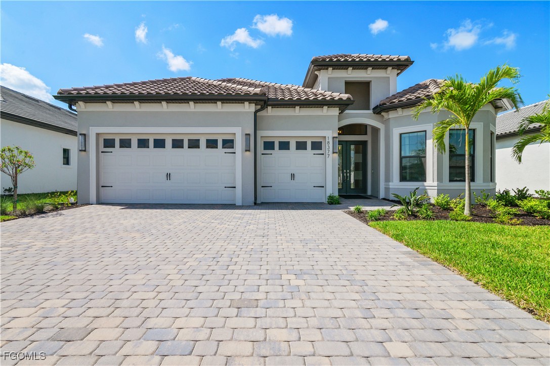 18377 Ridgeline Drive Estero, FL 33928 - Photo 2 of 50 a front view of a house with a garden