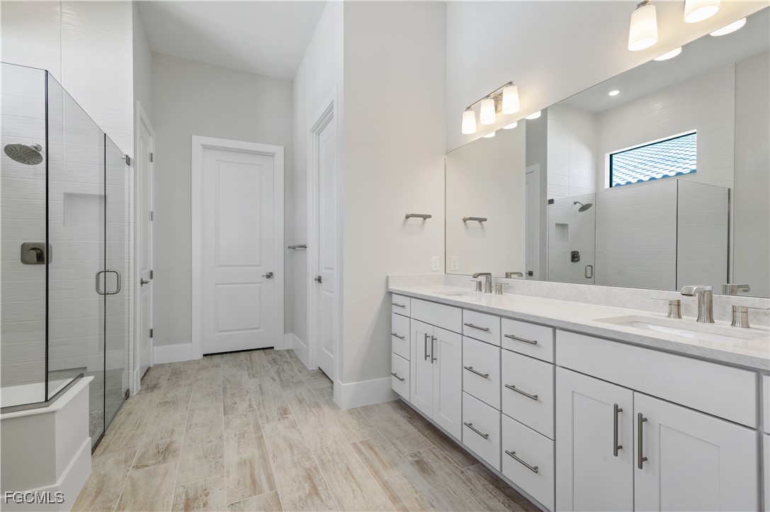 18377 Ridgeline Drive Estero, FL 33928 - Photo 24 of 50 a spacious bathroom with a double vanity sink toilet and shower