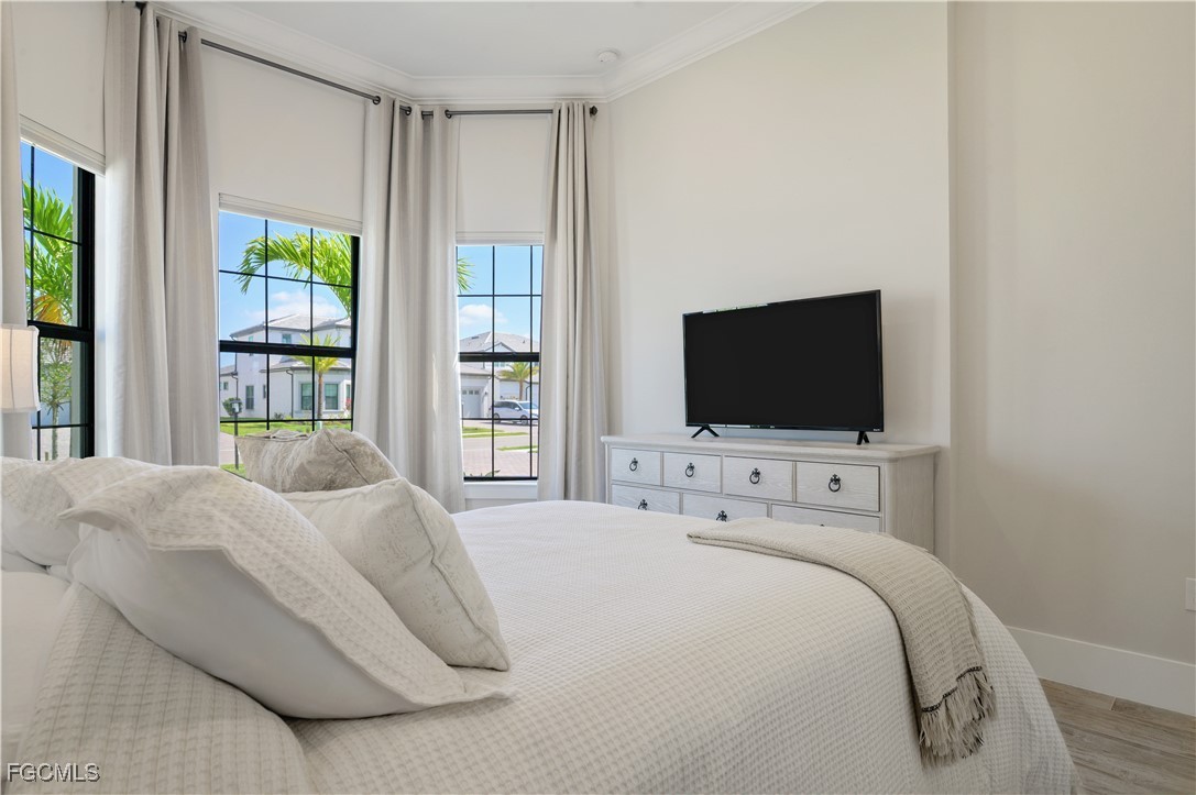 18377 Ridgeline Drive Estero, FL 33928 - Photo 32 of 50 a bedroom with a bed and a flat screen tv