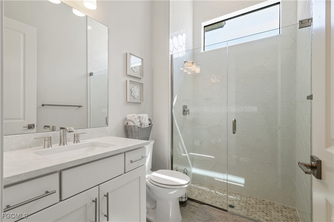 18377 Ridgeline Drive Estero, FL 33928 - Photo 36 of 50 a bathroom with a sink toilet and shower