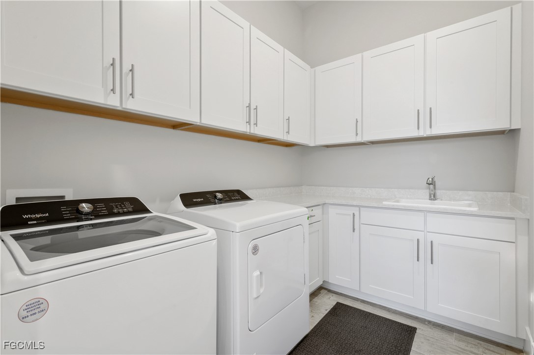 18377 Ridgeline Drive Estero, FL 33928 - Photo 37 of 50 a utility room with dryer and washer