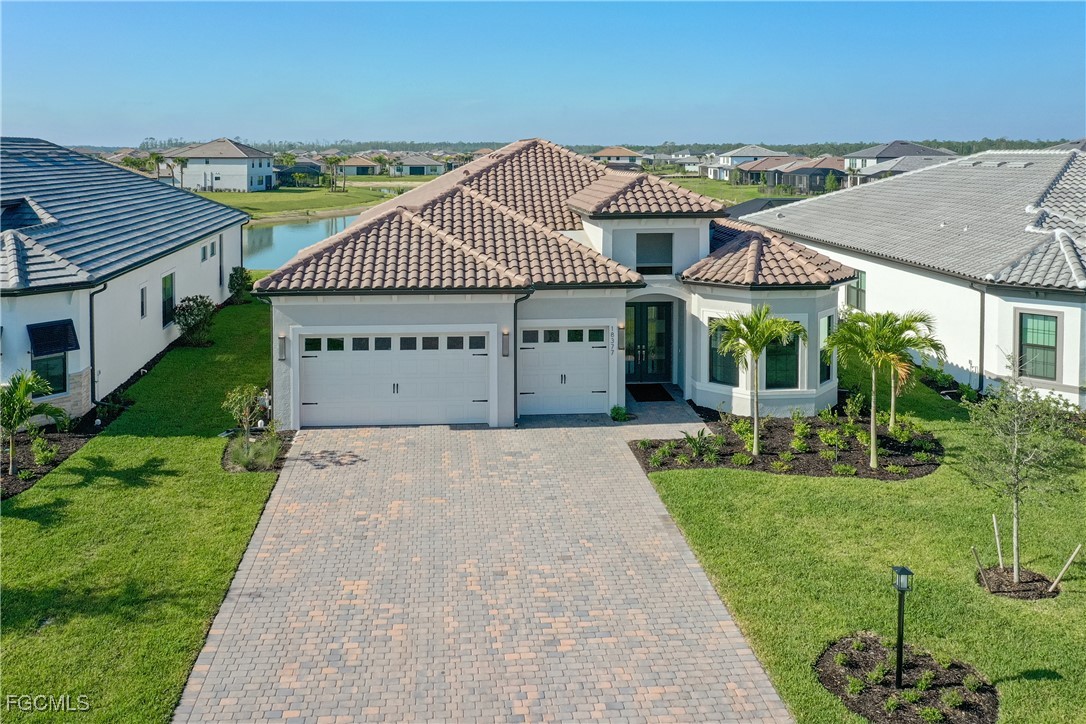 18377 Ridgeline Drive Estero, FL 33928 - Photo 40 of 50 a front view of a house with a yard