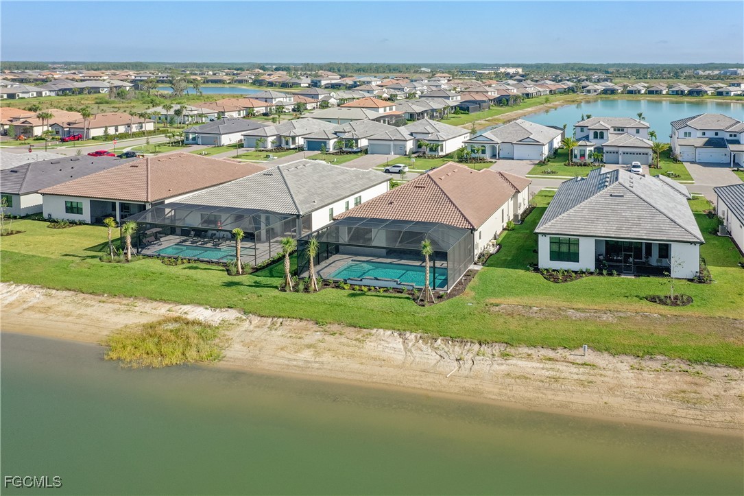 18377 Ridgeline Drive Estero, FL 33928 - Photo 41 of 50 an aerial view of multiple houses with a yard