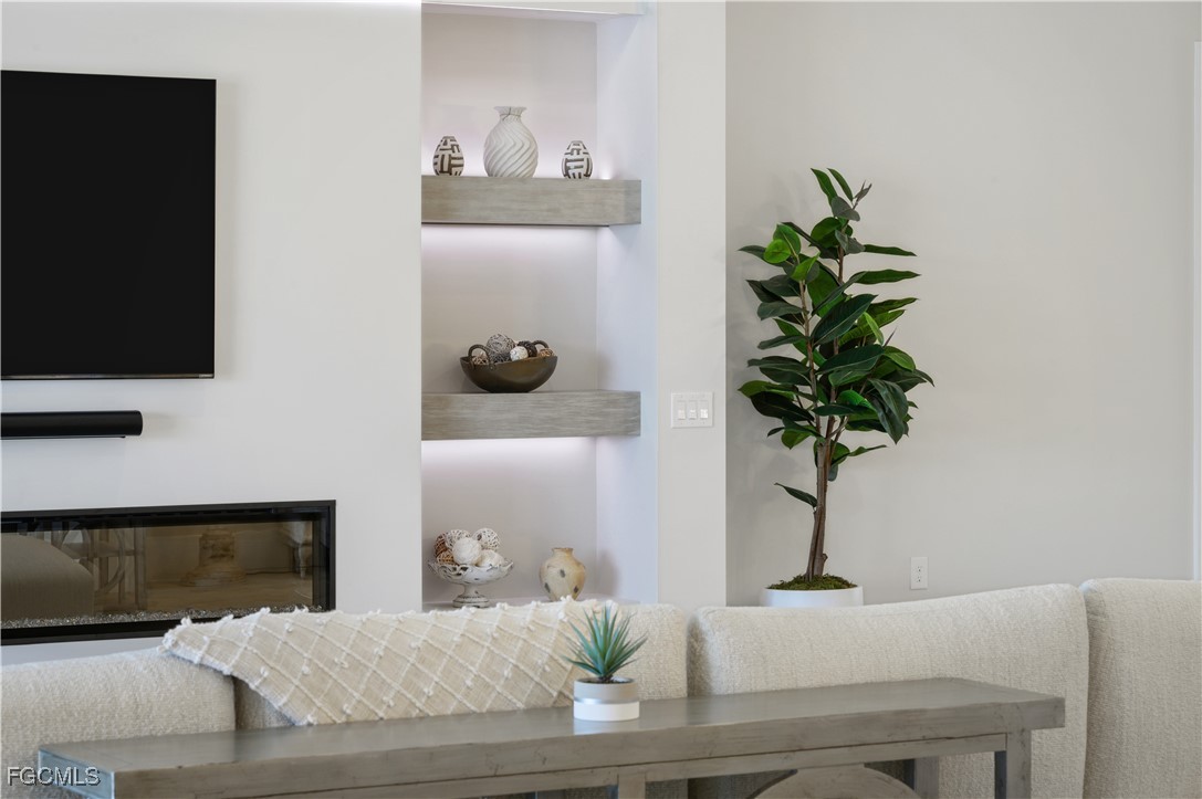 18377 Ridgeline Drive Estero, FL 33928 - Photo 9 of 50 a living room with furniture and a potted plant