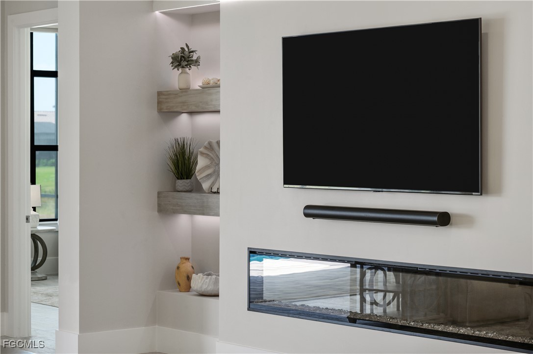 18377 Ridgeline Drive Estero, FL 33928 - Photo 10 of 50 a living room with a flat screen tv