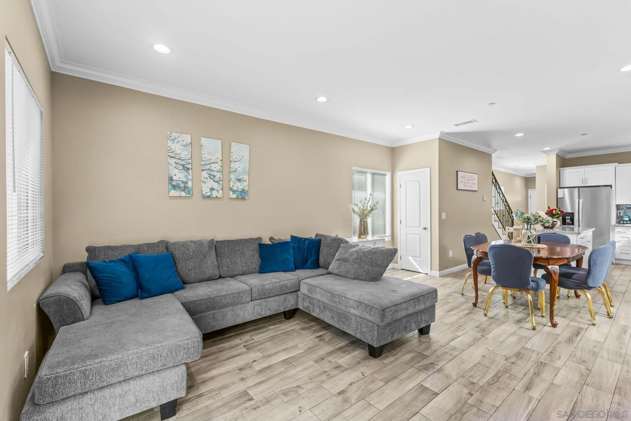 903 Concepcion Avenue Spring Valley, CA 91977 - Photo 23 of 69 a living room with furniture and a dining table with wooden floor