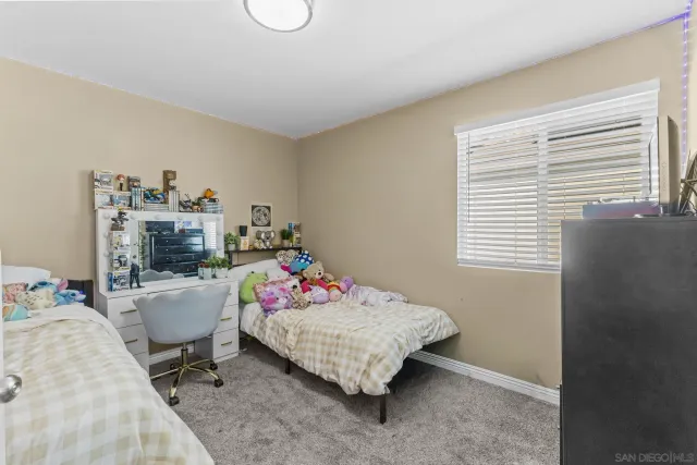 a bedroom with a bed and a television