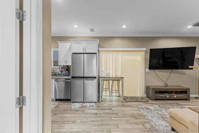 a kitchen with kitchen island a counter top space cabinets and stainless steel appliances