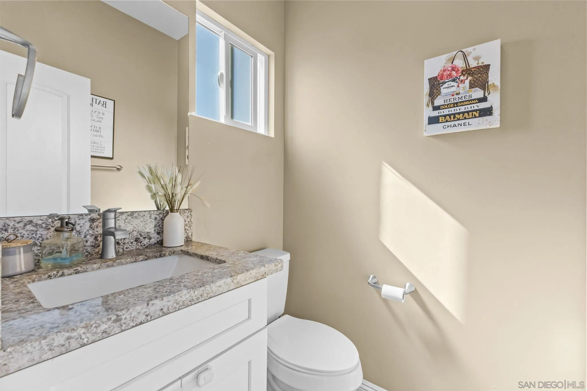 903 Concepcion Avenue Spring Valley, CA 91977 - Photo 46 of 69 a bathroom with a granite countertop sink mirror vanity and toilet