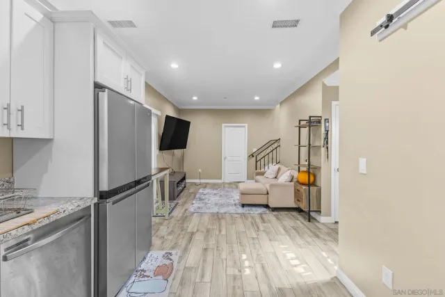 a living room with furniture and a kitchen view