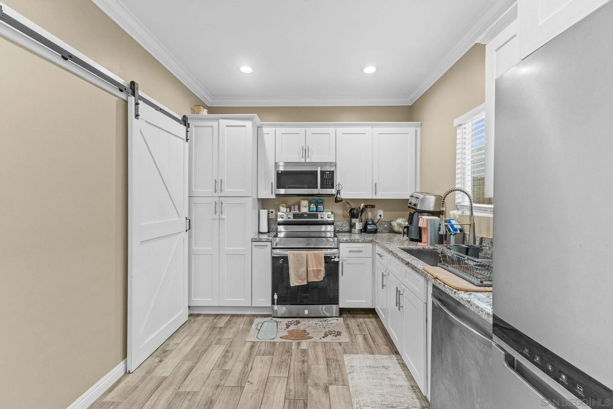 903 Concepcion Avenue Spring Valley, CA 91977 - Photo 50 of 69 a kitchen with stainless steel appliances granite countertop a stove a sink and a refrigerator