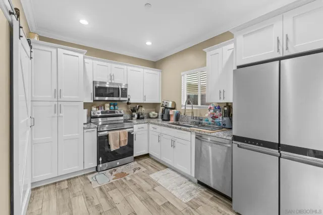 a view of a kitchen with electric appliances