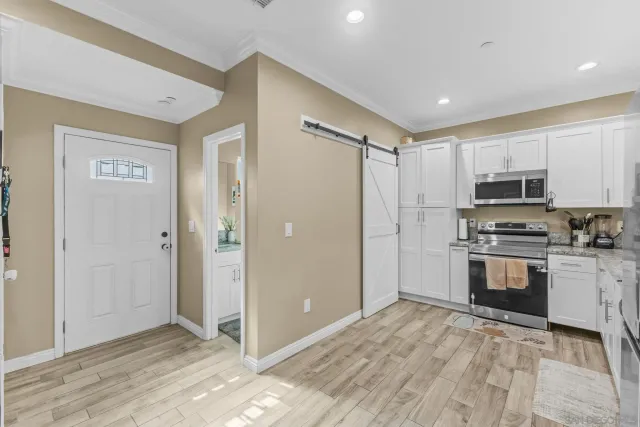 a bathroom with a granite countertop toilet sink and mirror