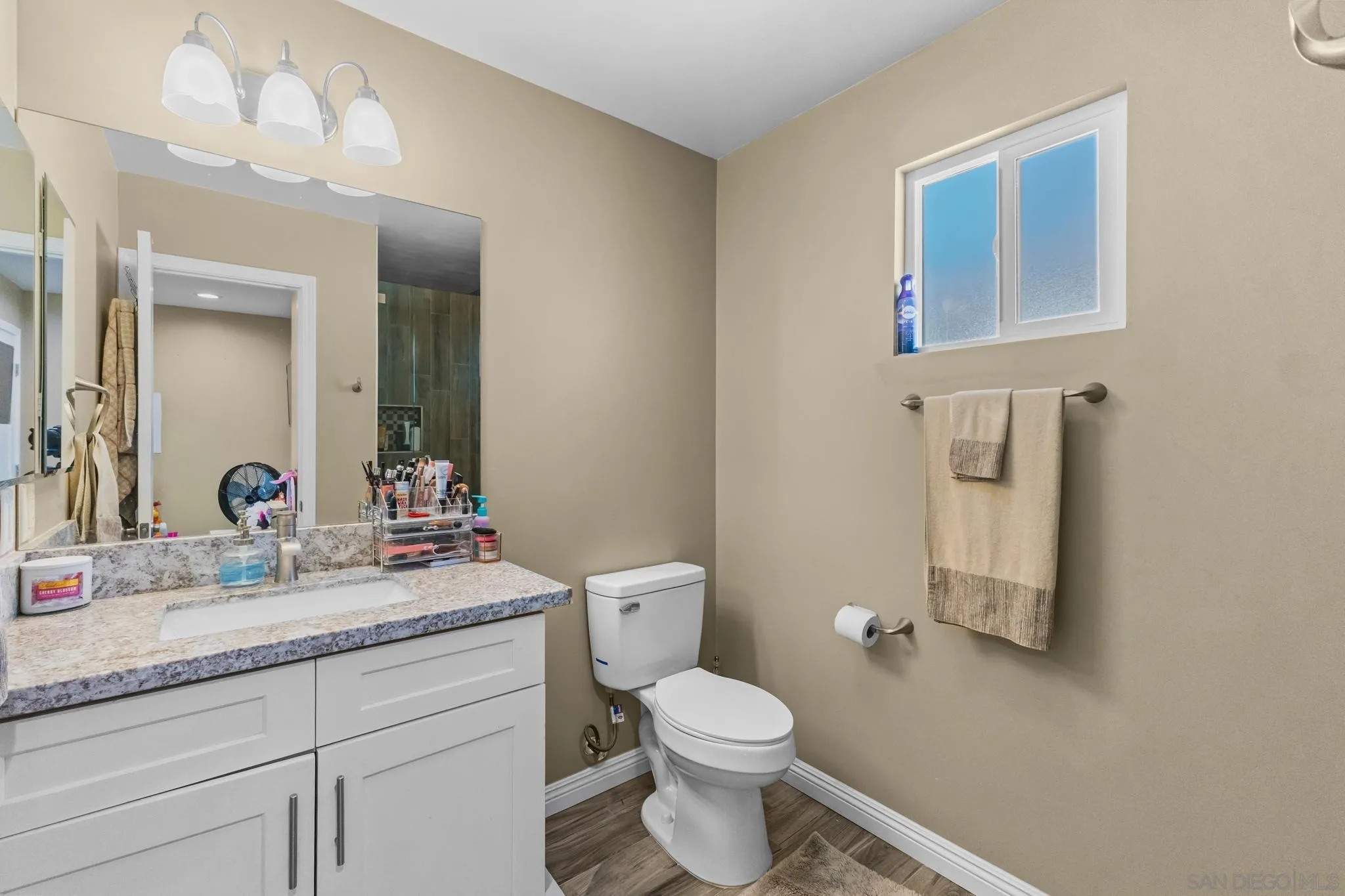 903 Concepcion Avenue Spring Valley, CA 91977 - Photo 63 of 69 a bathroom with a granite countertop toilet sink and mirror
