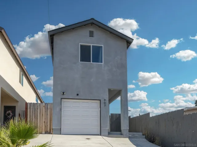 a view of a hallway with wooden floor and stairs