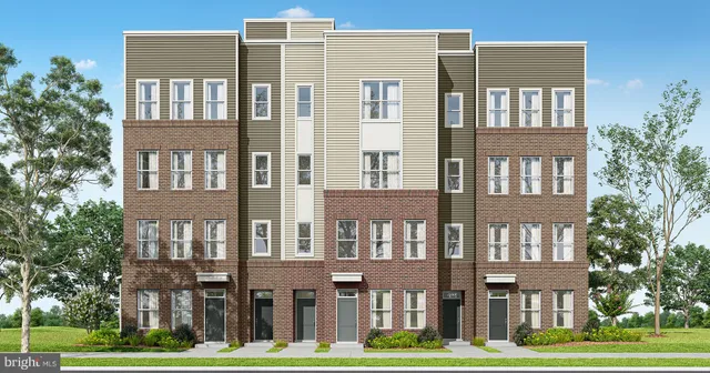 a front view of a residential apartment building with a yard