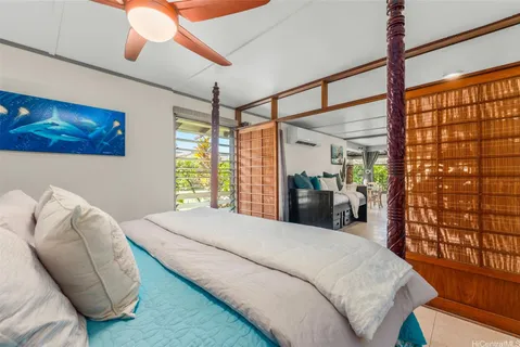 a bedroom with a large bed and a large window