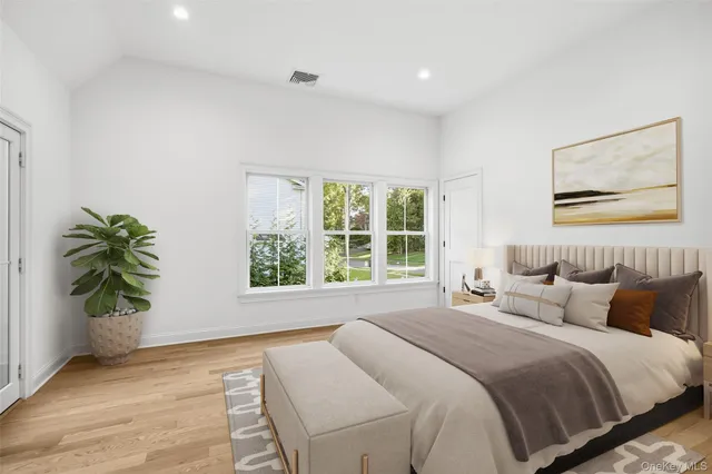 a bedroom with a bed and a potted plant