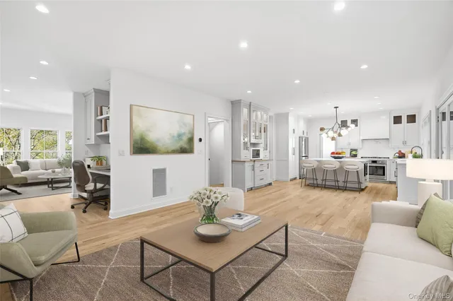 a living room with furniture and a view of kitchen