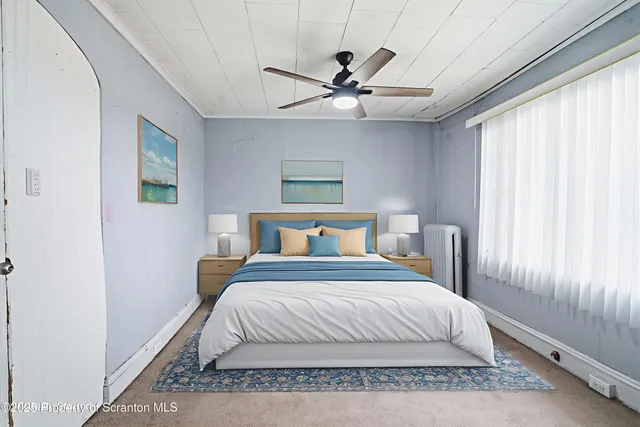 a view of an empty room with a ceiling fan