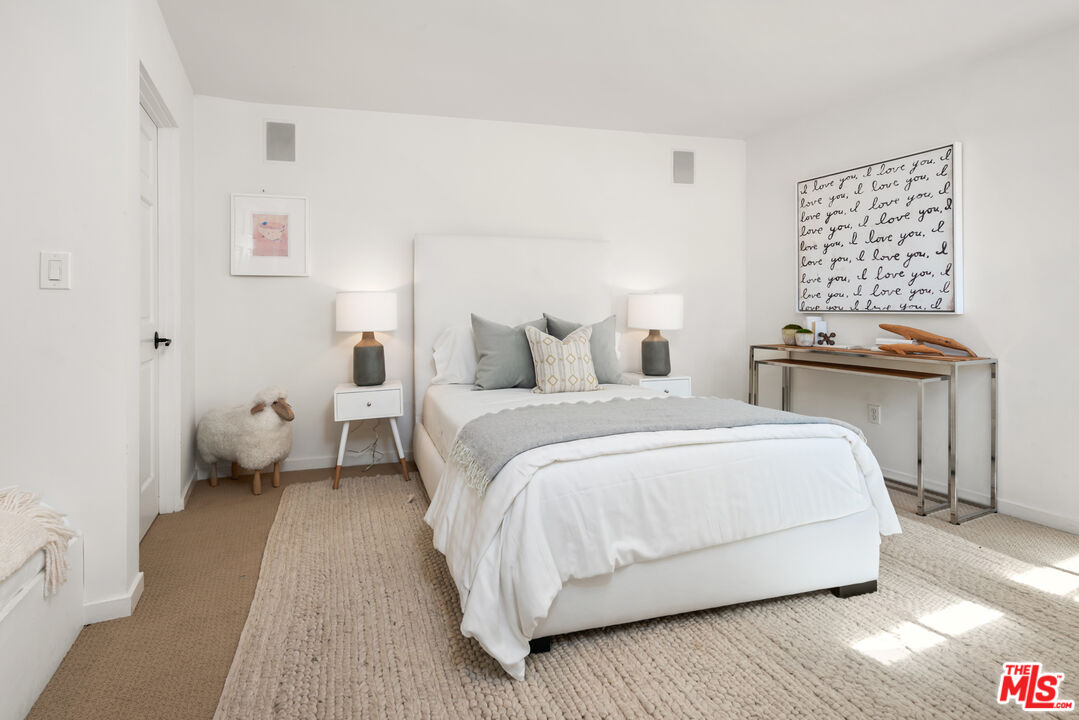 558 East Channel Road Santa Monica, CA 90402 - Photo 12 of 34 a bedroom with a bed and wooden floor