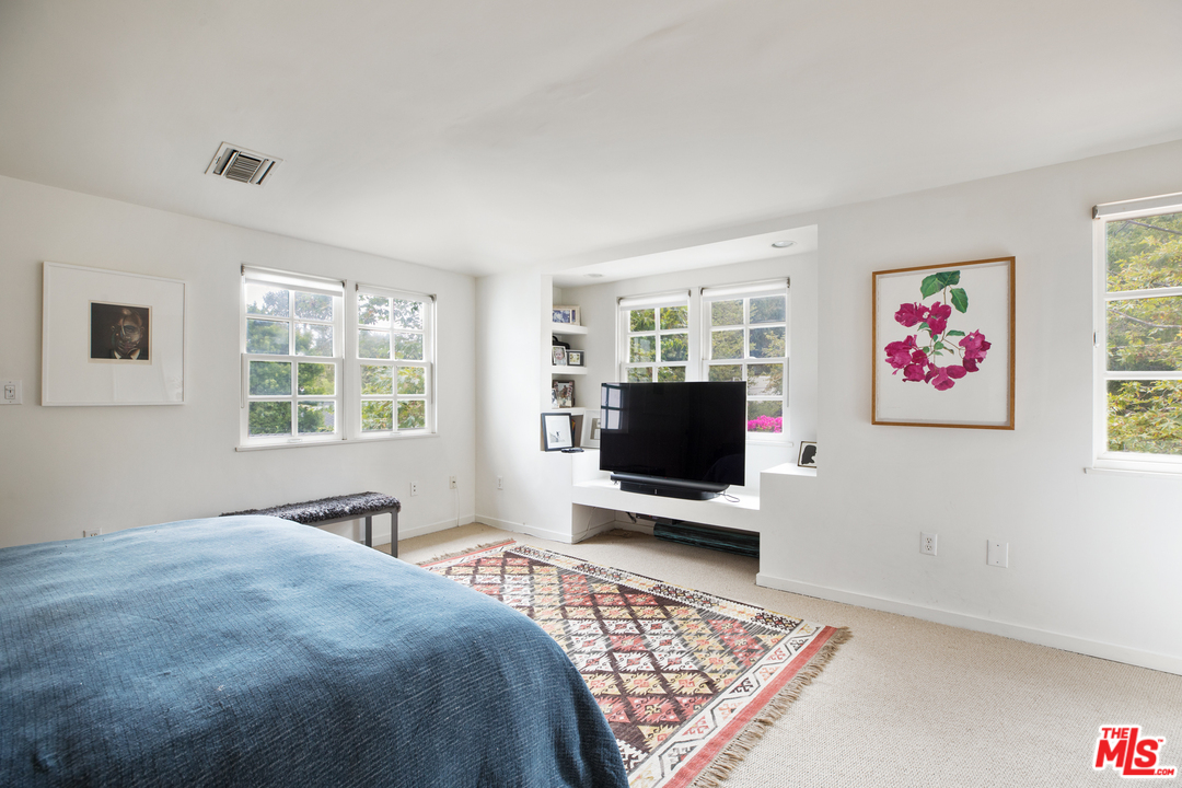 558 East Channel Road Santa Monica, CA 90402 - Photo 22 of 34 a bedroom with furniture window and flat screen tv