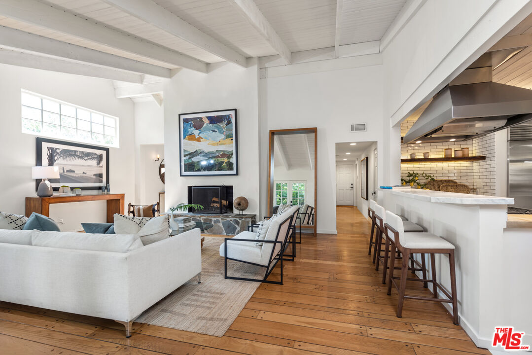 558 East Channel Road Santa Monica, CA 90402 - Photo 6 of 34 a living room with fireplace furniture and a wooden floor