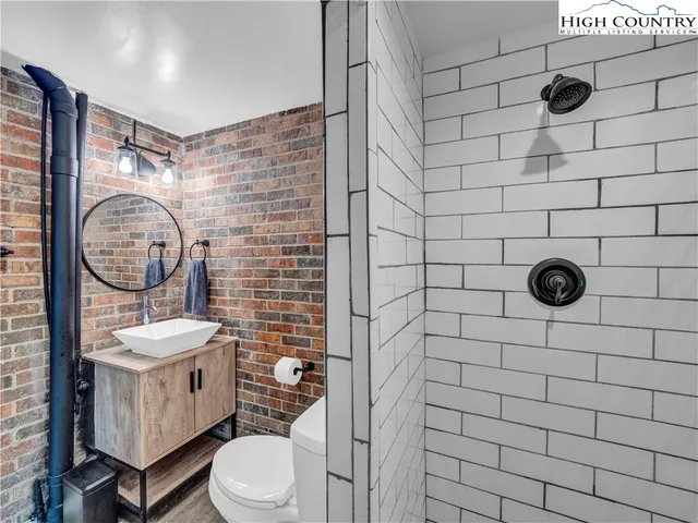 a bedroom with a bed and a flat tv screen