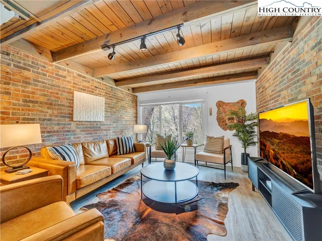 a bedroom with a bed and a dresser next to a window