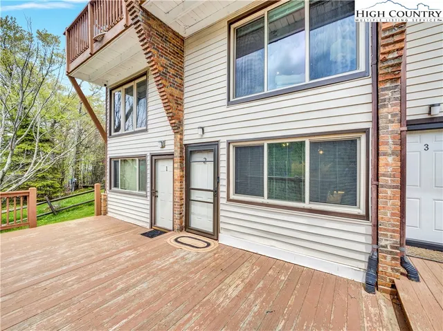 a living room with furniture a fireplace and a table