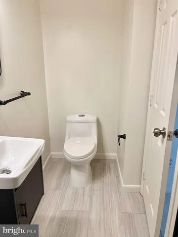 a white toilet sitting next to a white sink