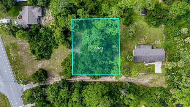 an aerial view of residential house with an outdoor space and seating