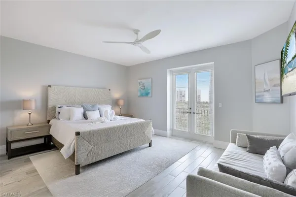 a spacious bedroom with a bed couch and window