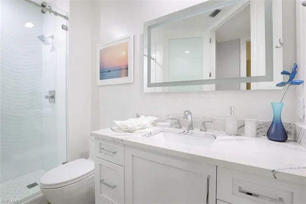 a room with a bed and white walls