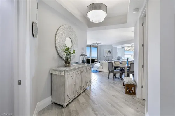 a living room with furniture a rug and a chandelier
