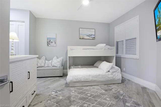 a bathroom with a granite countertop sink a toilet and a mirror