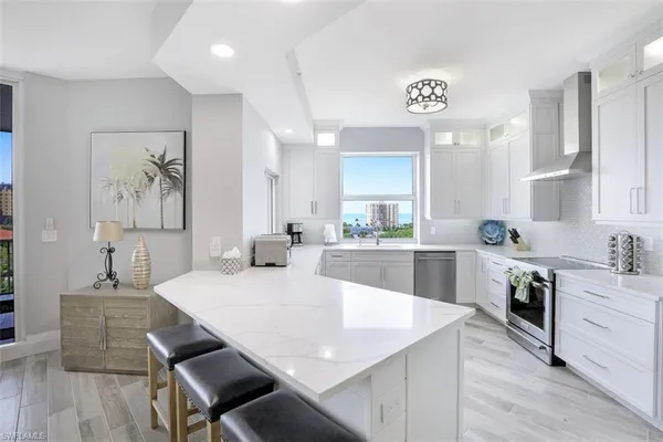 a large kitchen with a table and chairs