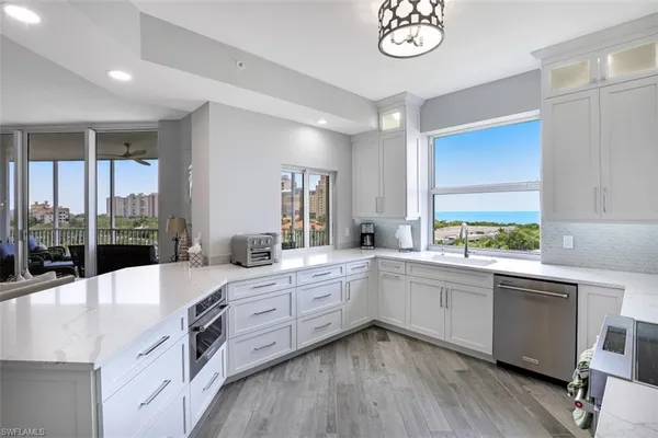 a large kitchen with a lot of counter space and a sink