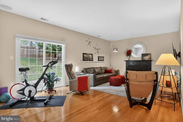 a view of a workspace with furniture and a gym machine