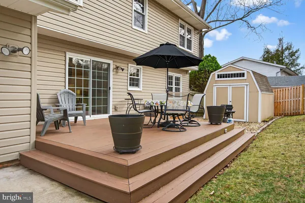 a view of house with patio and outdoor seating