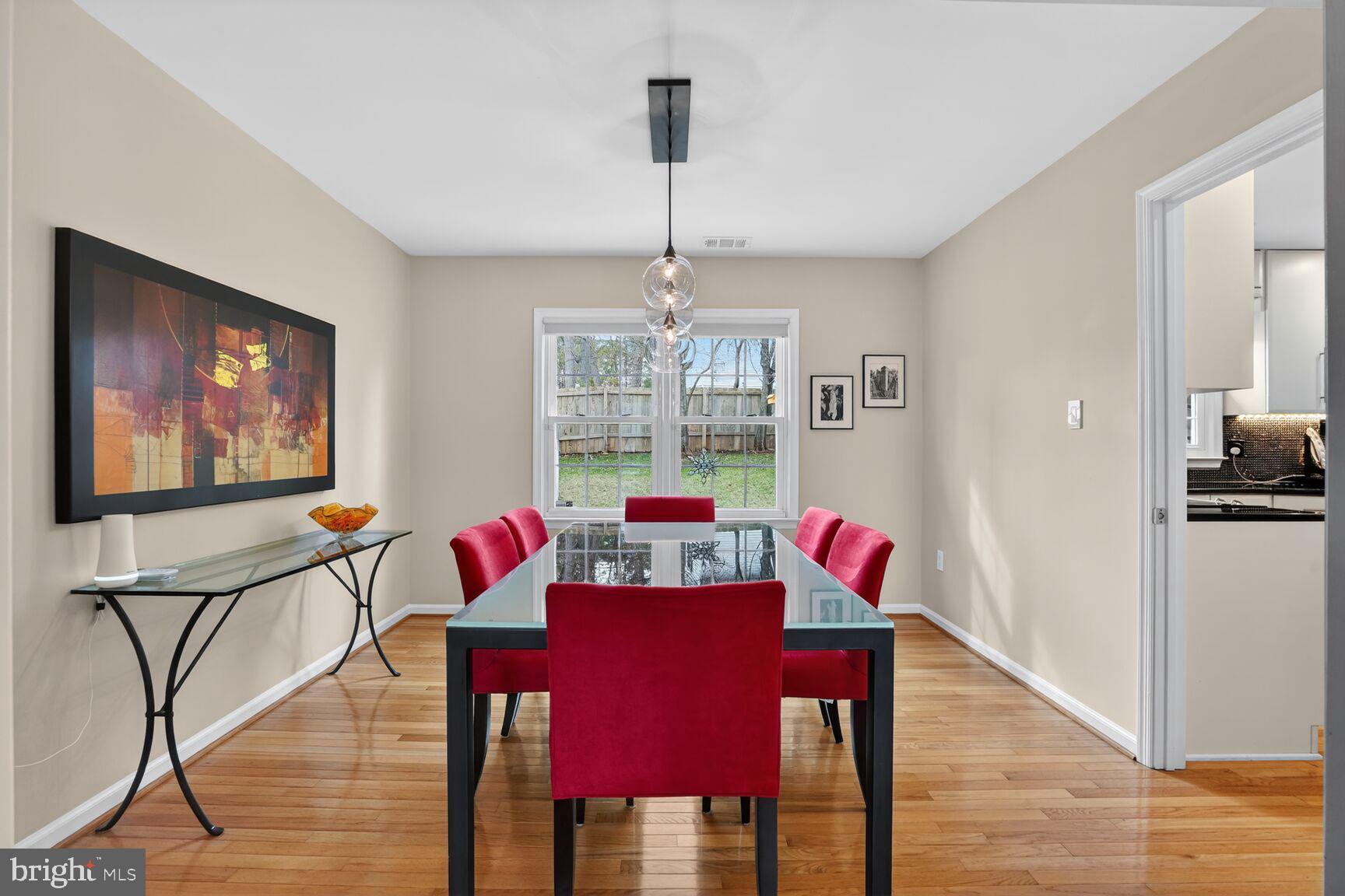 1354 Shallow Ford Road Herndon, VA 20170 - Photo 10 of 34 a view of a dining room with furniture a chandelier and wooden floor
