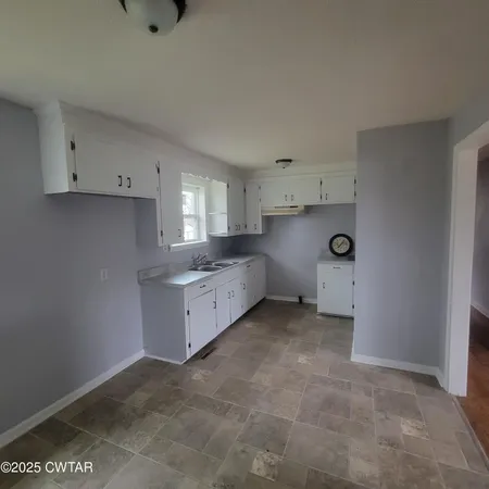 a kitchen with a cabinets and window